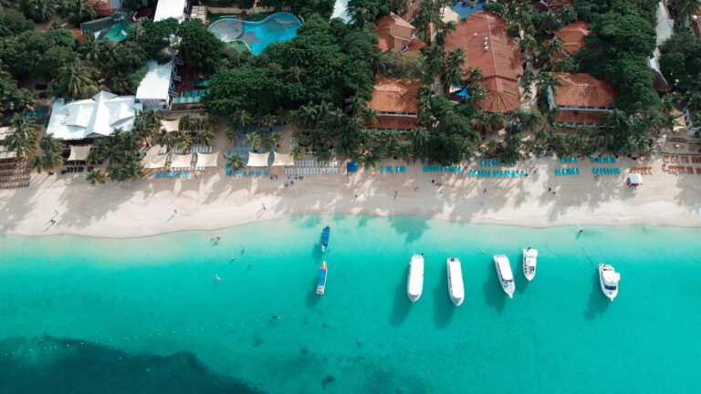 Aerial view of West Bay Beach, Roatán, with boats on turquoise water